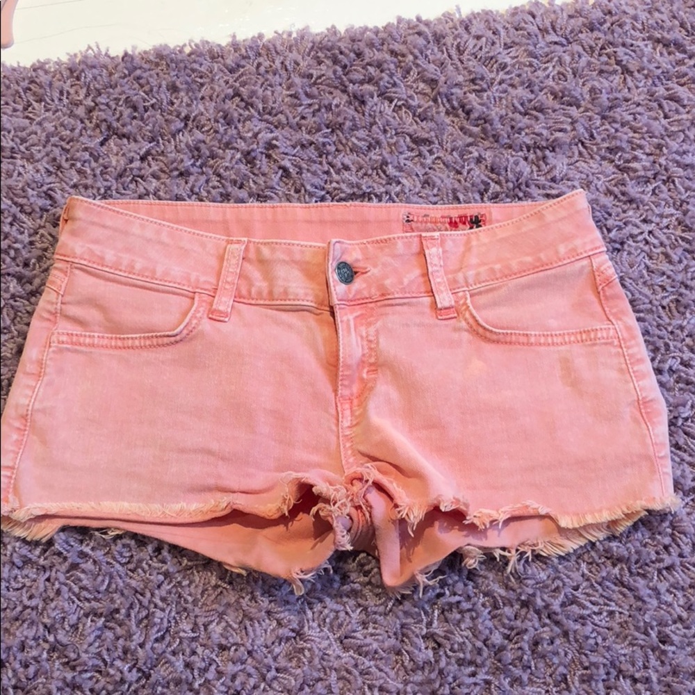 Coral colored jean shorts